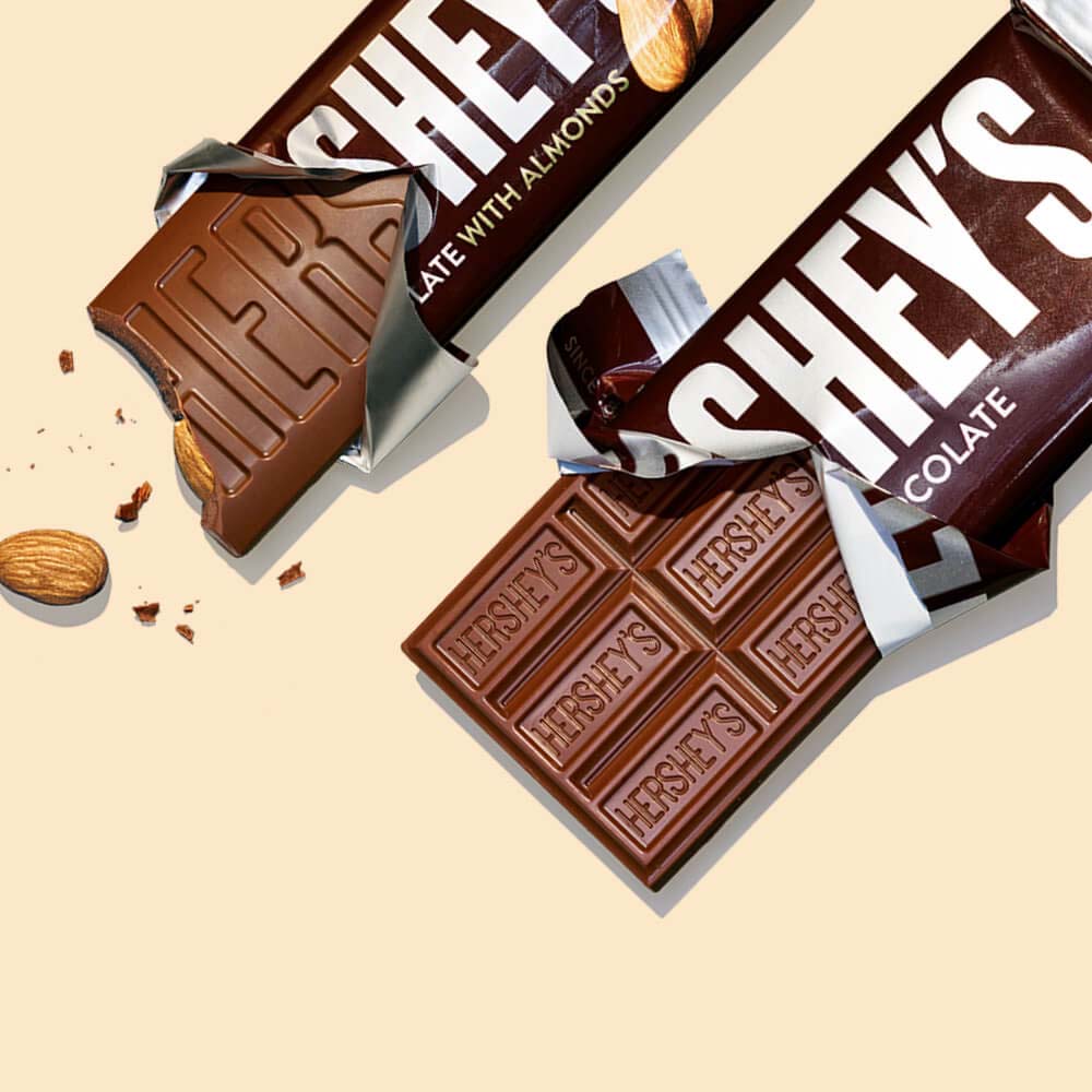 pair of partially unwrapped hersheys milk chocolate candy bars