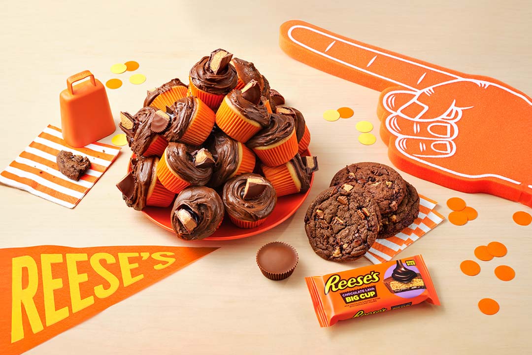 table featuring an assortment of reeses game day recipes, products, and sports party favors